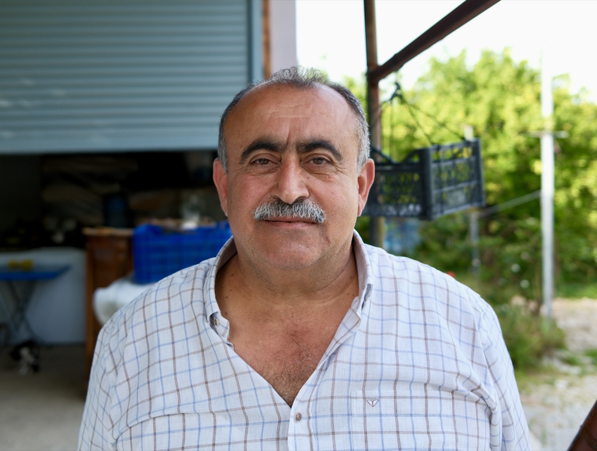 Portrait of the village chief of Vakıflı in front of his workshop